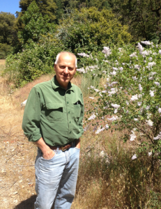Tom Carlson enjoying a flowering Ceanothus bush. Photo courtesy of Brent Mishler.